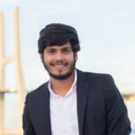 portrait of good looking smiling arabic man in suit